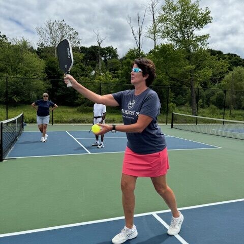 Volunteer Coach Maura Keenan teaching our members about Pickleball